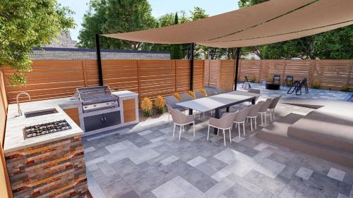 a patio with a table and chairs and a grill at The Einstein Room in Boise