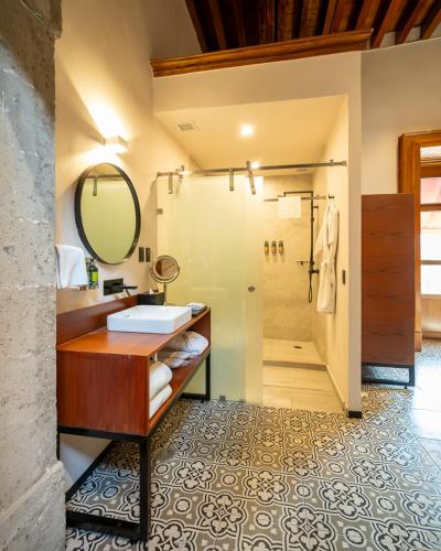 a bathroom with a sink and a shower at Casa de la Luz Hotel Boutique in Mexico City