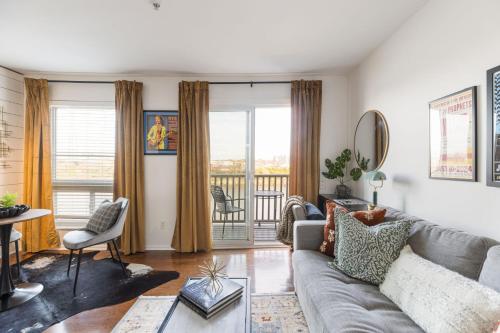a living room with a couch and a balcony at Downtown Nashville Riverfront unit 790 in Nashville