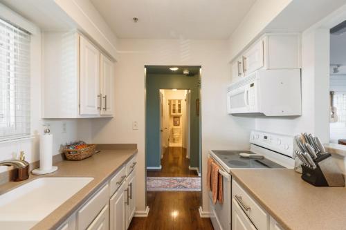 a kitchen with white cabinets and a sink at Downtown Nashville Riverfront unit 790 in Nashville