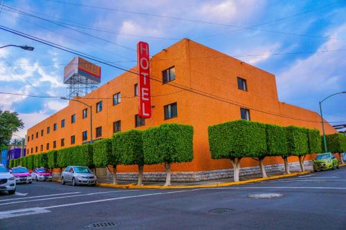 an orange building with a sign on the side of it at Hotel Puente in Mexico City