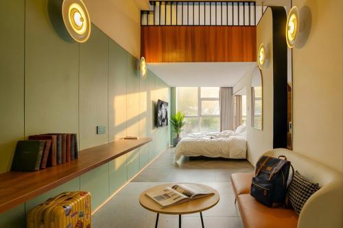 a room with a bed and a couch and a table at Still apartment in Guangzhou