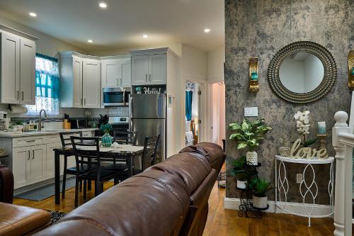 a kitchen and dining room with a couch in it at Top Floor with Skylight Brooklyn in Brooklyn