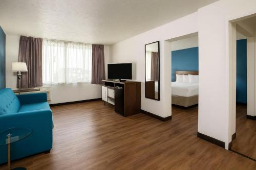 a hotel room with a bed and a blue couch at Spokane Boutique Hotel in Spokane