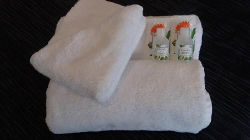 a white towel with three bottles on it at Baden Lodge Motel - PRIVATE SPA Bath in Rotorua