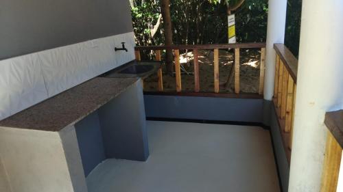 a bathroom with a sink on a balcony at Vila mar azul in Imbassai
