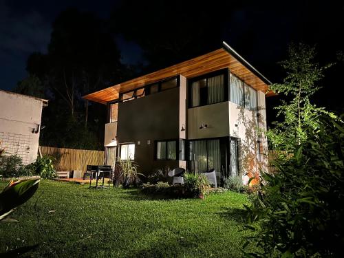 a house with a lawn in front of it at Rincon de Luna, Cabañas in Mar del Plata
