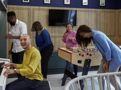 a group of people playing a game with a table at Aparthotel Adagio Paris Suresnes Longchamp in Suresnes