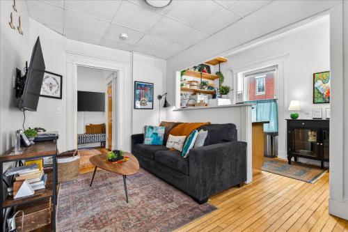 a living room with a couch and a tv at Charming 1BR Steps from Church Street - Downtown in Burlington