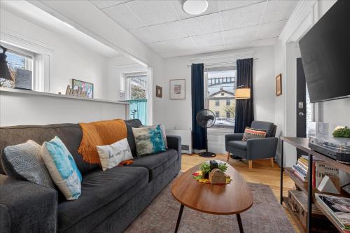 a living room with a couch and a table at Charming 1BR Steps from Church Street - Downtown in Burlington