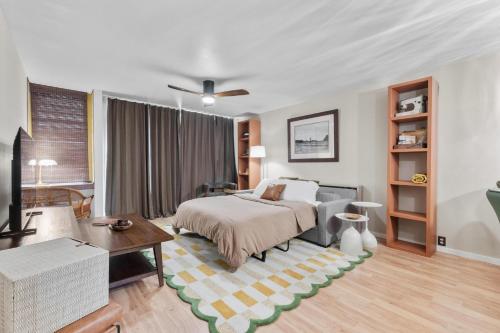 a bedroom with a bed and a living room at The Landing at Kailua Bay in Kailua-Kona