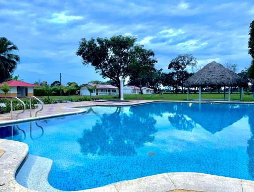 a large swimming pool with blue water at Hotel Campestre Cinco Estrellas in Villavicencio
