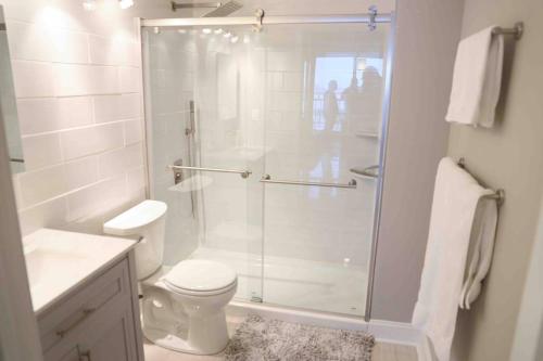 a bathroom with a glass shower with a toilet at Serenity Escapes Waterfront Atlantic City Condo with Balcony & Free Parking in Atlantic City