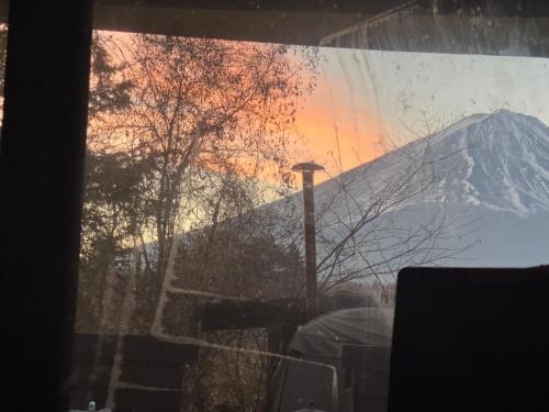una ventana con vistas a una montaña cubierta de nieve en Ondolphin, en Narusawa