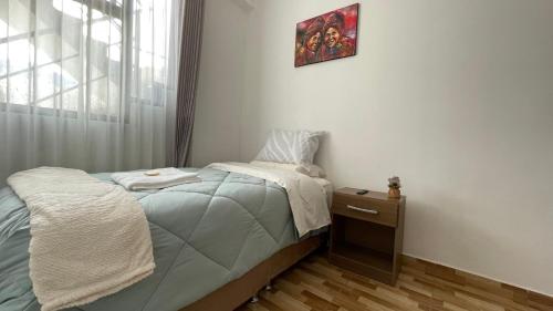 En eller flere senge i et værelse på Departamento en Urubamba