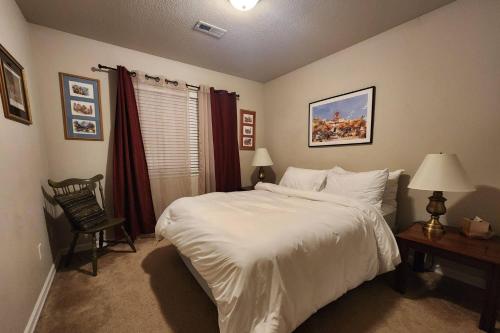 a bedroom with a large white bed and a desk at Dundee Park Place in Dundee