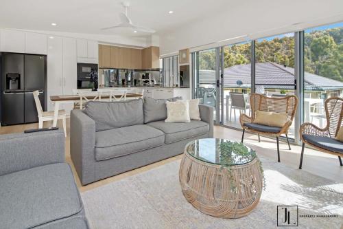 a living room with a couch and a table at Bay Dream. in Malua Bay