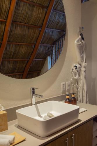 a bathroom with a sink and a mirror at Torre Marsai By MrW in Higuera Blanca