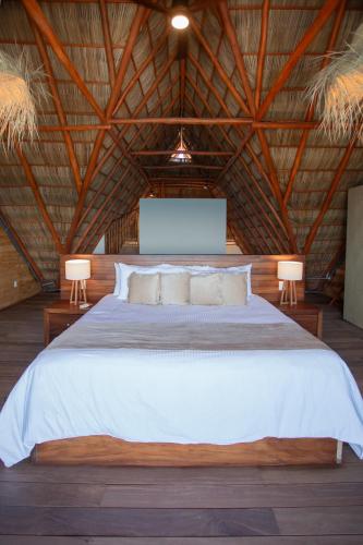 a bedroom with a large bed with two lamps at Torre Marsai By MrW in Higuera Blanca