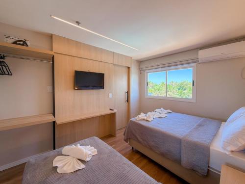 a hotel room with a bed and a tv at Apto Luxo Gran Lençóis Atins 503 in Barreirinhas