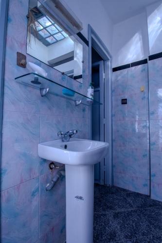 a bathroom with a white sink and a shower at Beachside Retreat in Imi ouadar in Agadir