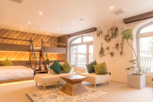 a bedroom with a bunk bed and a couch at BUB RESORT Yatsugatake in Hokuto