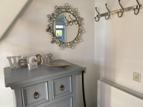 a bathroom with a vanity with a mirror on the wall at Holiday home with 1 bedroom in Medemblik