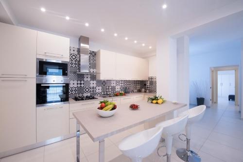 a kitchen with a counter with a bowl of fruit on it at Al Corso Apartments by AMALFIVACATION in Minori