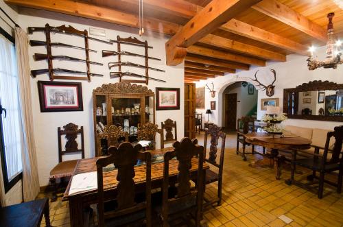 a dining room with a wooden table and chairs at Molino La Boticaria in Marchena