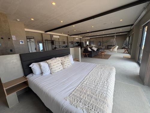a bedroom with a large bed and a living room at Grand Ocean View Suite with Private Pool in La Paz