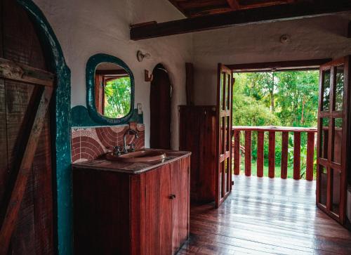 a bathroom with a sink and an open door at Hostel Casa de Nelly in San Agustín