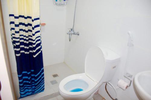 a bathroom with a toilet and a sink at Mondavi II Condo Unit 306 in Silang
