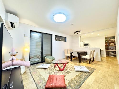 a living room with a table and a dining room at 海神ハウス in Funabashi