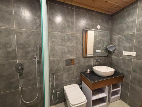 a bathroom with a sink and a shower and a toilet at Mastiff Citadel RC in Chūharpur