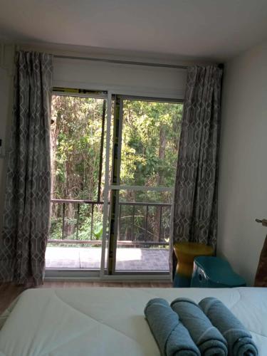 a bedroom with a bed and a large window at My Home Koh Kood1 in Ko Kood