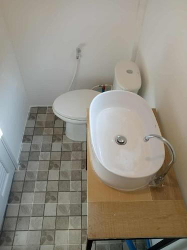 a bathroom with a white sink and a toilet at My Home Koh Kood1 in Ko Kood