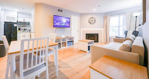 a kitchen and living room with a table and a couch at Disney Universal Family Resort # Pool # Gym in Orlando
