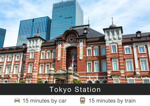 an old brick building in a city with skyscrapers at Tokyu Stay Suidobashi in Tokyo