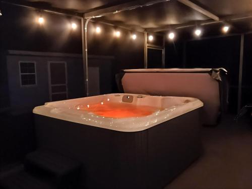 a bath tub in a dark room with lights at st pete pool house in St Petersburg