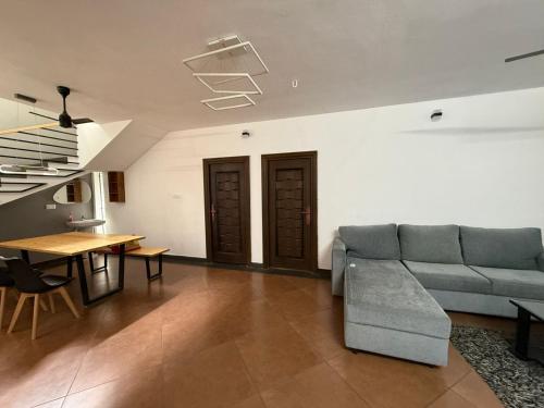 a living room with a couch and a table at Modern Independent House in Tenkāsi