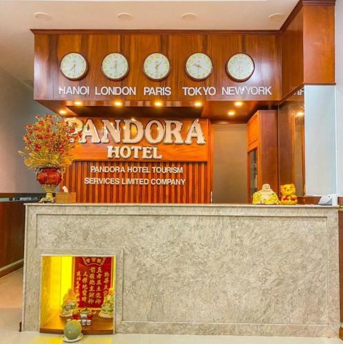 a sign for a hotel with clocks above a counter at Pandora Hotel Cần Thơ in Can Tho