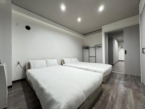 Postel nebo postele na pokoji v ubytování シェール松岡