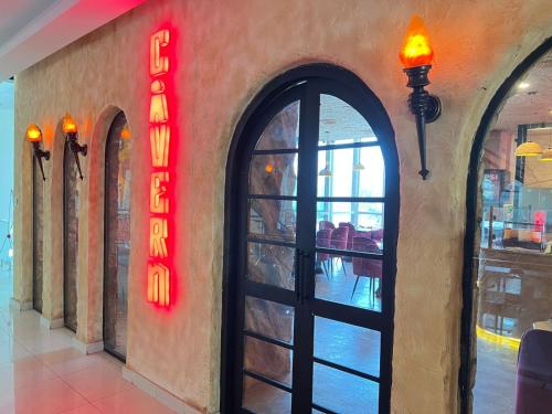 an entrance to a restaurant with a sign on the wall at Elysium Tower Premium Serviced Apartments Facing Centaurus Mall Islamabad in Islamabad