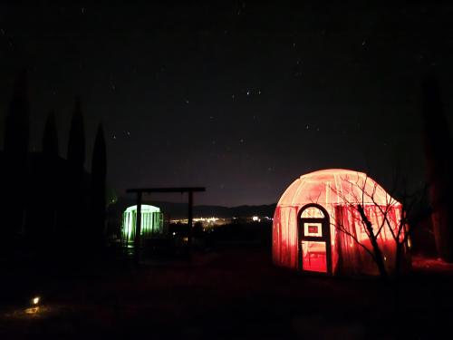 an igloo lit up in the dark at night at Stargazing Retreats Homestay in Camp Verde