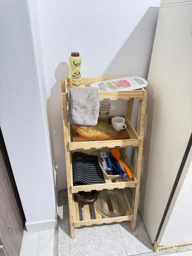 a small wooden shelf in a hallway with tools at Dulce Descanso in Salta