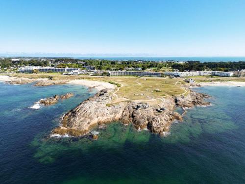 an island in the ocean next to the water at Sofitel Quiberon Thalassa sea & spa in Quiberon