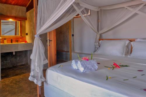 Ένα ή περισσότερα κρεβάτια σε δωμάτιο στο Beach Villa l'Heure Bleue