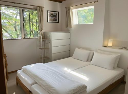 Ένα ή περισσότερα κρεβάτια σε δωμάτιο στο Chalet Tsugaike