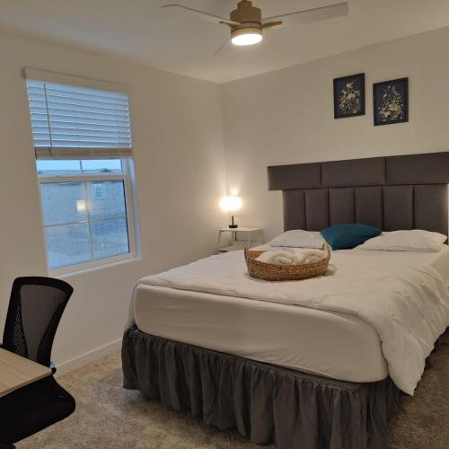 a bedroom with a large bed with a basket on it at The Orchid house !! Your home away from home Gateway to Yosemite & UC Merced this for a Room in Merced