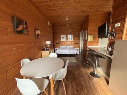a room with a bed and a table and chairs at Arbegain Etxea in Aizarna